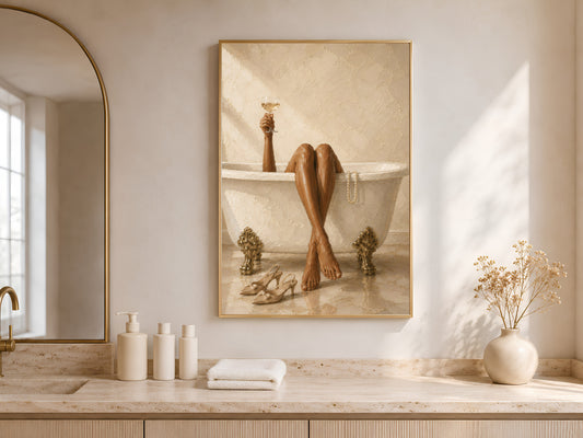 Framed luxury bath wall art leaning against a warm white wall in a minimalist entryway with neutral ceramics and soft natural light through an arched window
