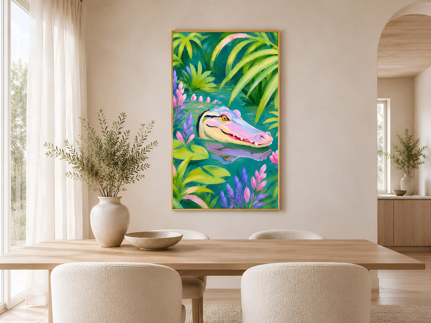 Colorful alligator tropical print in a gold frame displayed in a Scandinavian dining room with white walls, natural wood table, and woven pendant light