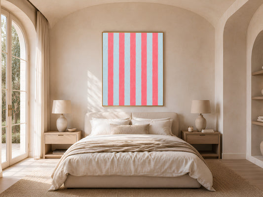 Framed pink blue stripe print above the bed in a neutral arched bedroom