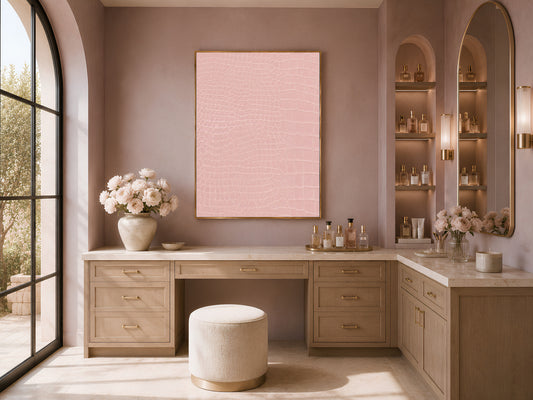 Framed pink crocodile texture print above a wood vanity nook with flowers and a mauve accent wall.