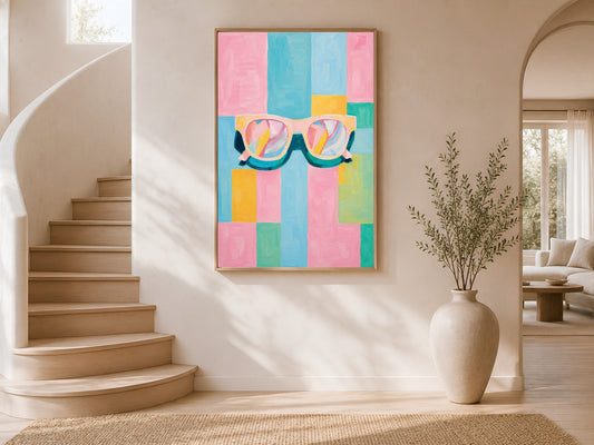 Framed impasto retro sunglasses print on white wall in modern entryway with curved staircase and tall ceramic vase