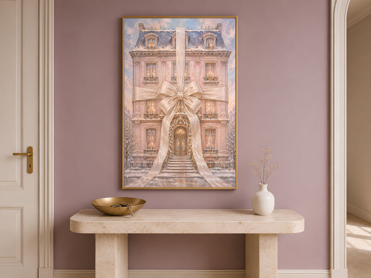 Pink chateau Christmas print framed on a wall above an entryway console table with a bowl