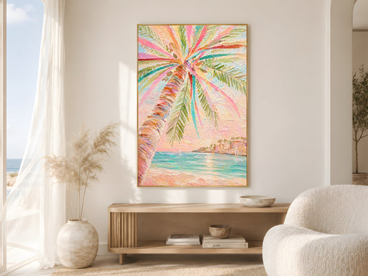 Colorful tropical palm tree impasto print in gold frame above wooden sideboard in warm minimalist living room with cream bouclé chair and dried botanicals