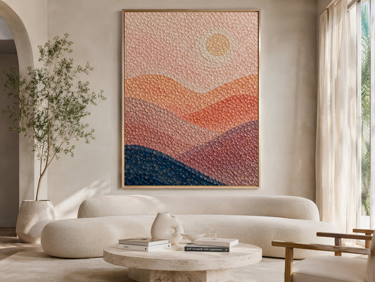 Abstract sunset pointillist print above a curved linen sofa in a bright minimalist living room with olive tree and warm neutral decor