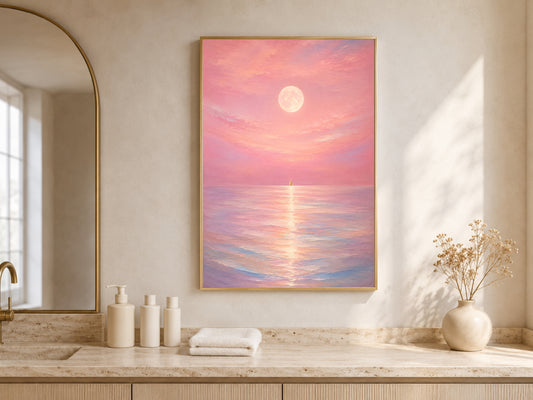 Pink moon ocean print framed above a bathroom vanity with candles and towels