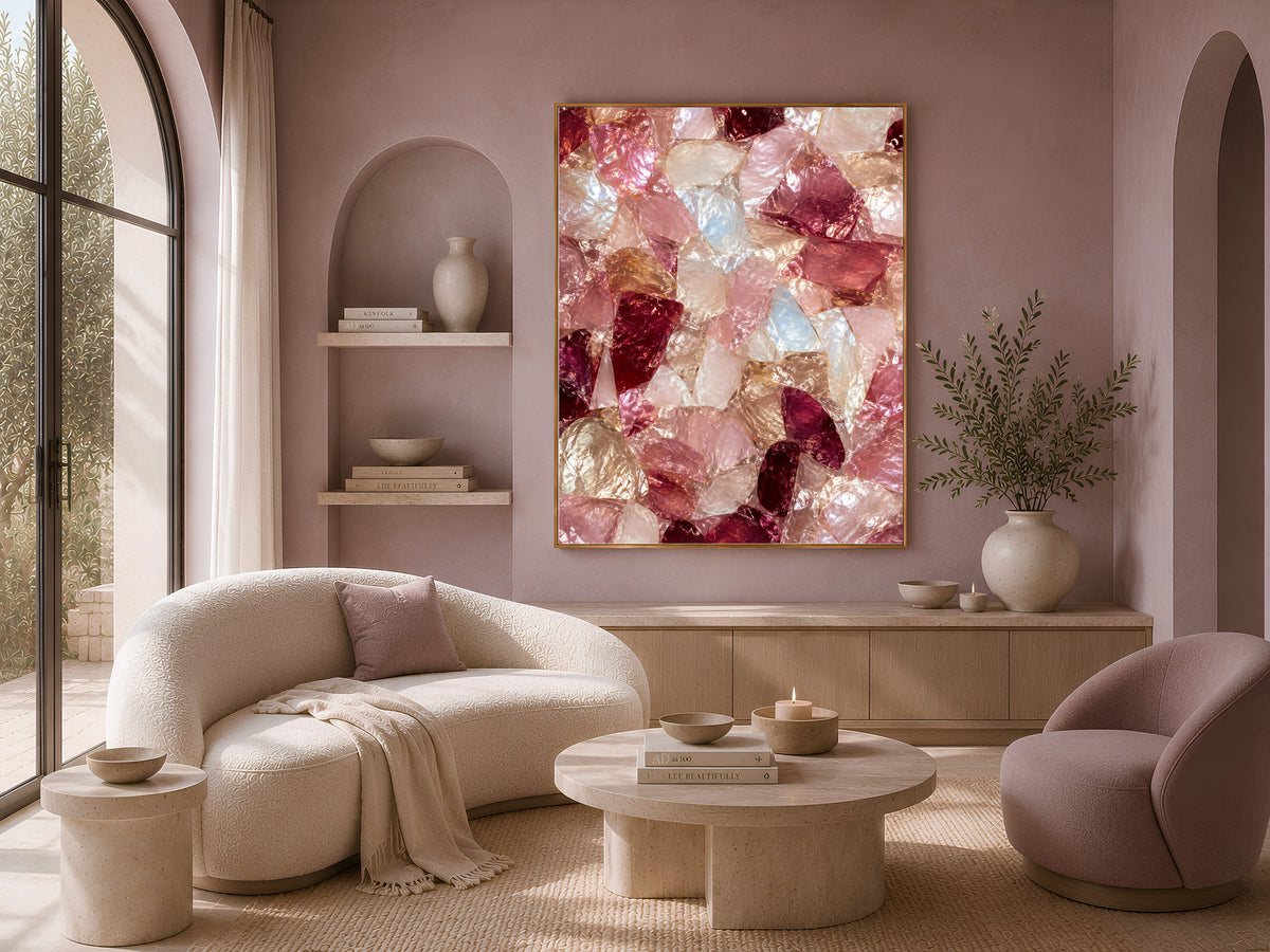 Pink crystal abstract print framed above a curved boucle sofa in a warm neutral living room