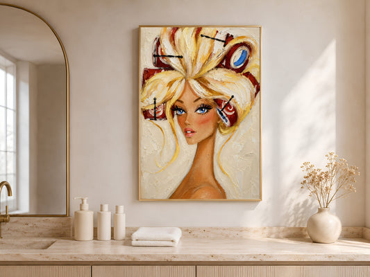 Framed retro pin-up hair rollers portrait above a wood vanity nook with a vase and towels.