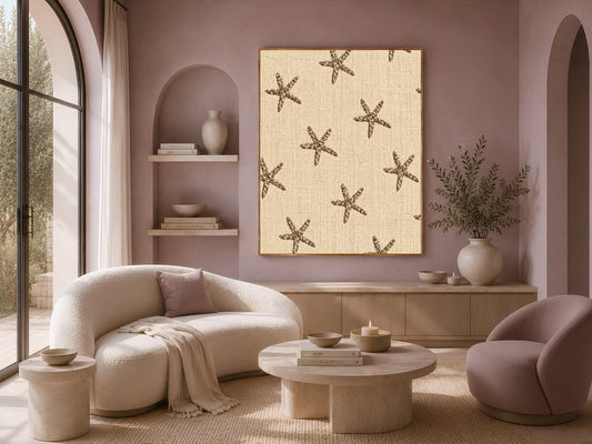 Embroidered starfish wall art framed on a mauve wall above a cream sofa and accent chairs