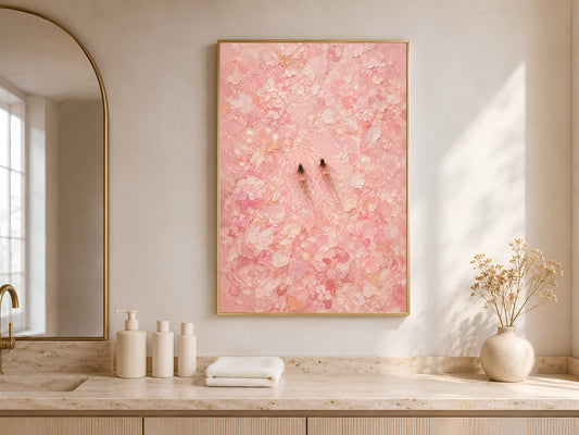 Framed pink swimmers wall art styled on a light oak sideboard with white ceramic vases and soft neutral decor beside a bright window
