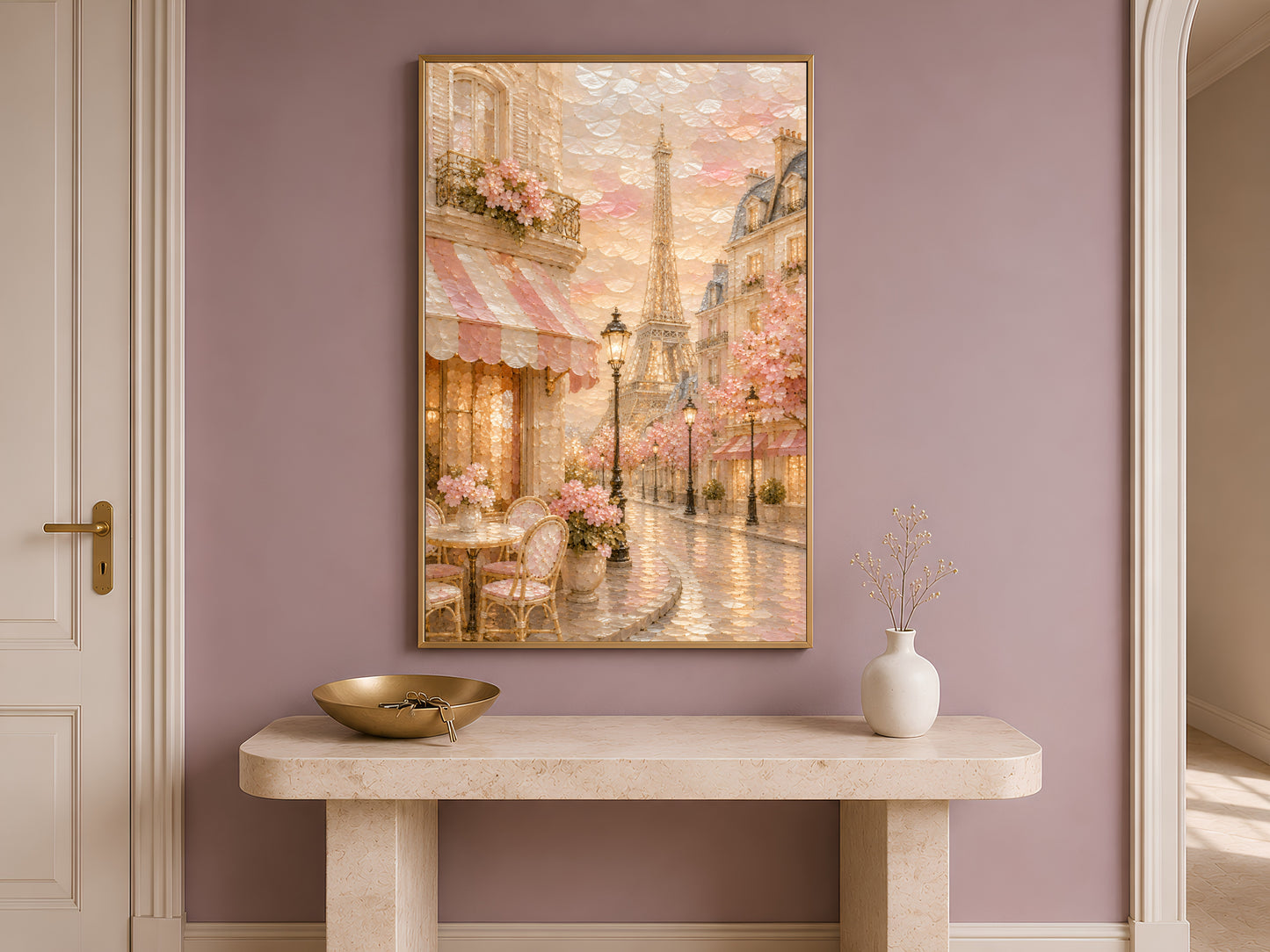 Paris cafe print framed in gold displayed above console table in bright neutral hallway
