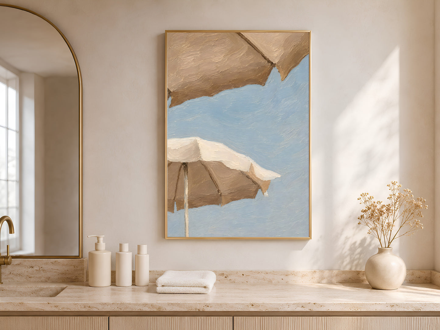 Beach umbrella impasto print in a thin gold frame displayed in a bright minimalist bathroom with arched doorway, warm sand tones, and soft natural light
