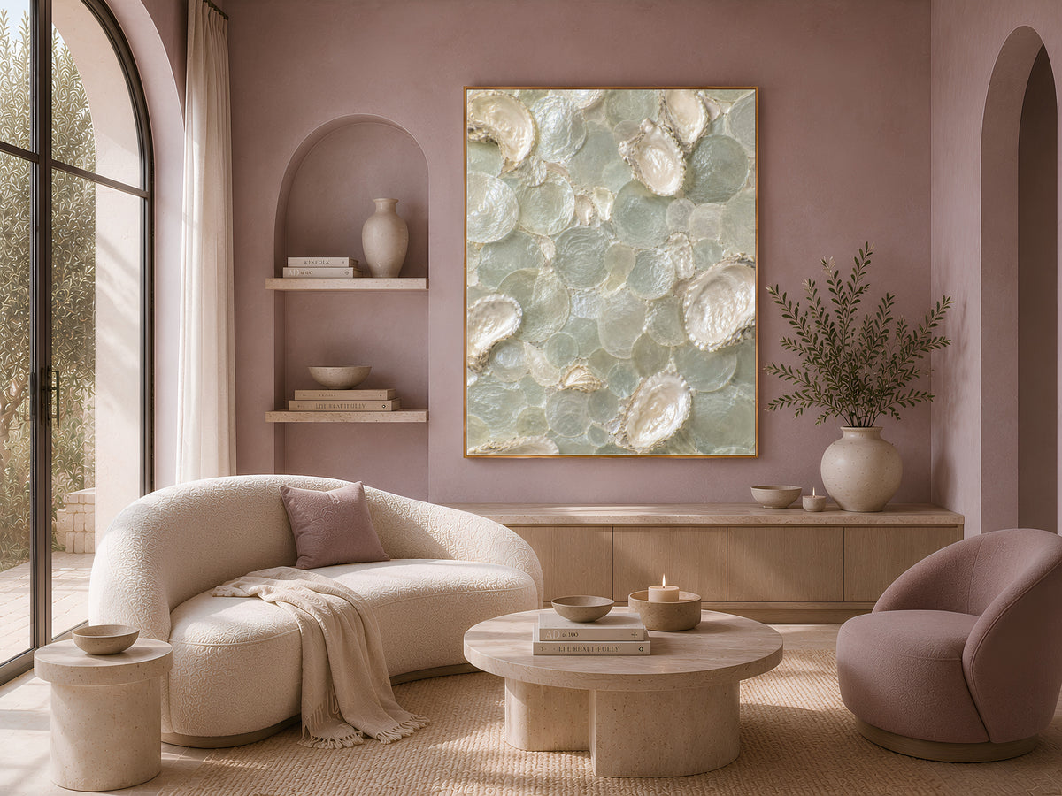 Framed coastal wall art above a cream sofa in a warm, minimalist living room