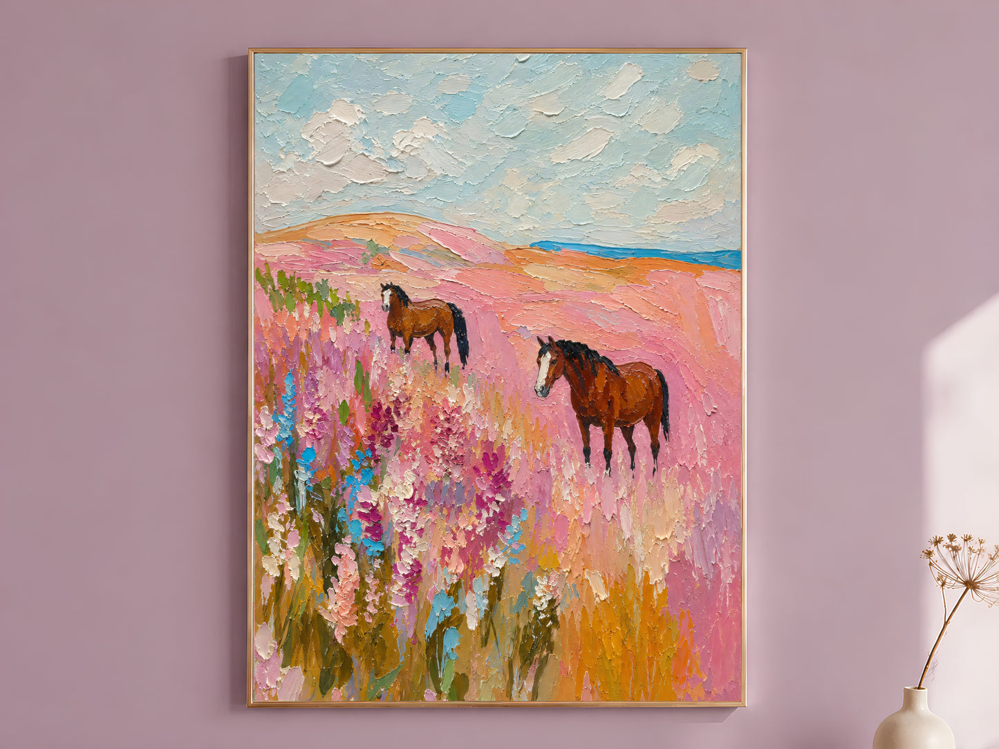 Pink wildflower horse painting in a thin gold frame on a dusty lilac wall
