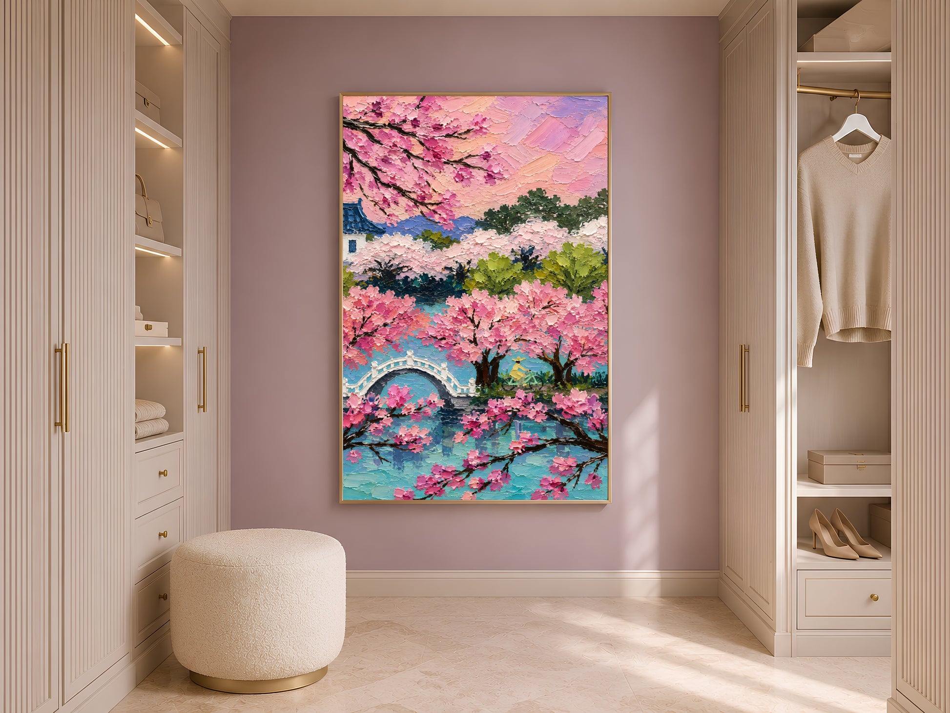 Cherry blossom sakura landscape print in gold frame in styled dressing room with wardrobe and cream ottoman
