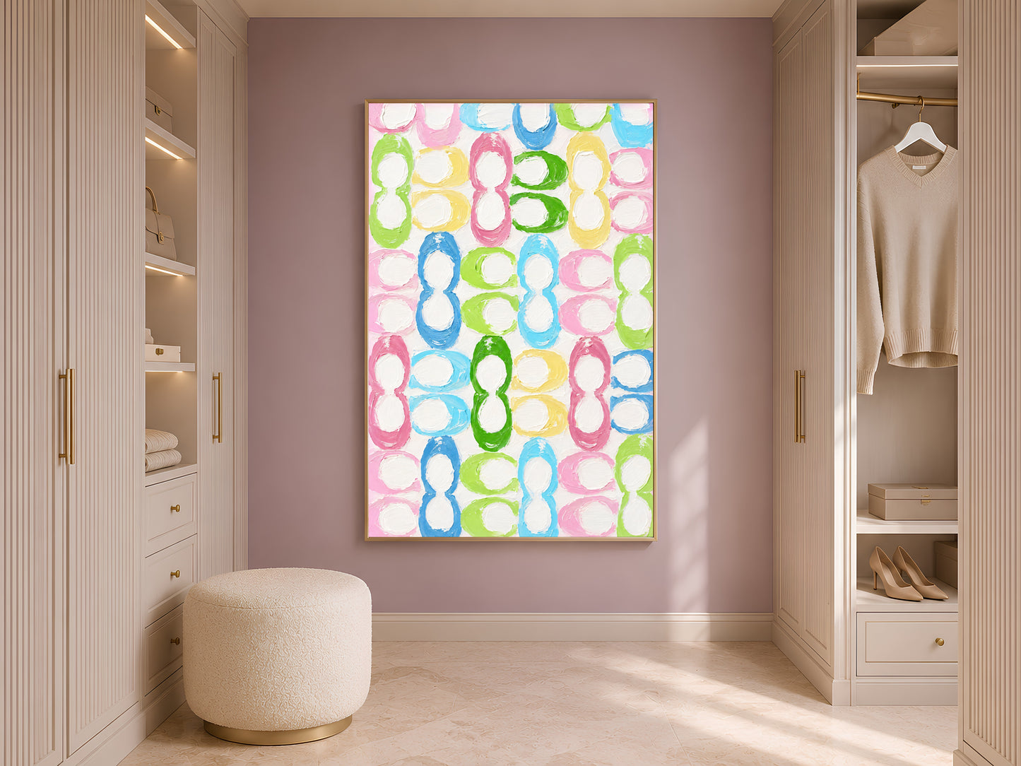 Colorful retro loop pattern wall art in gold frame in styled dressing room with wardrobe and cream ottoman

