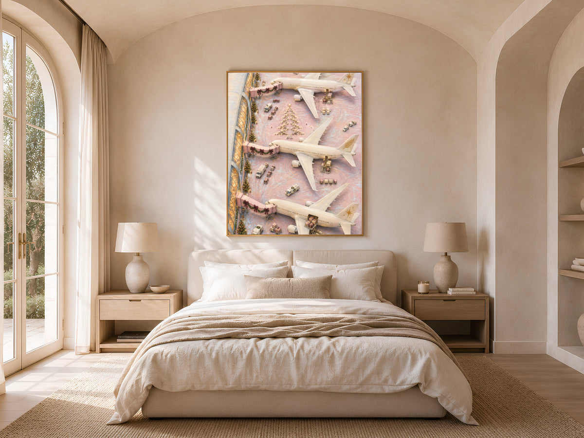 Pink Christmas airplane painting above bed in sunlit bedroom with arched window