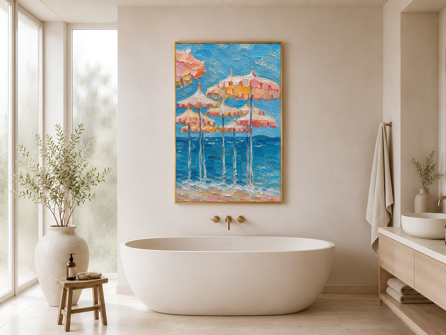 Gold-framed pink beach umbrella wall art in a bright minimalist bathroom beside a freestanding white bathtub and gold wall-mounted taps
