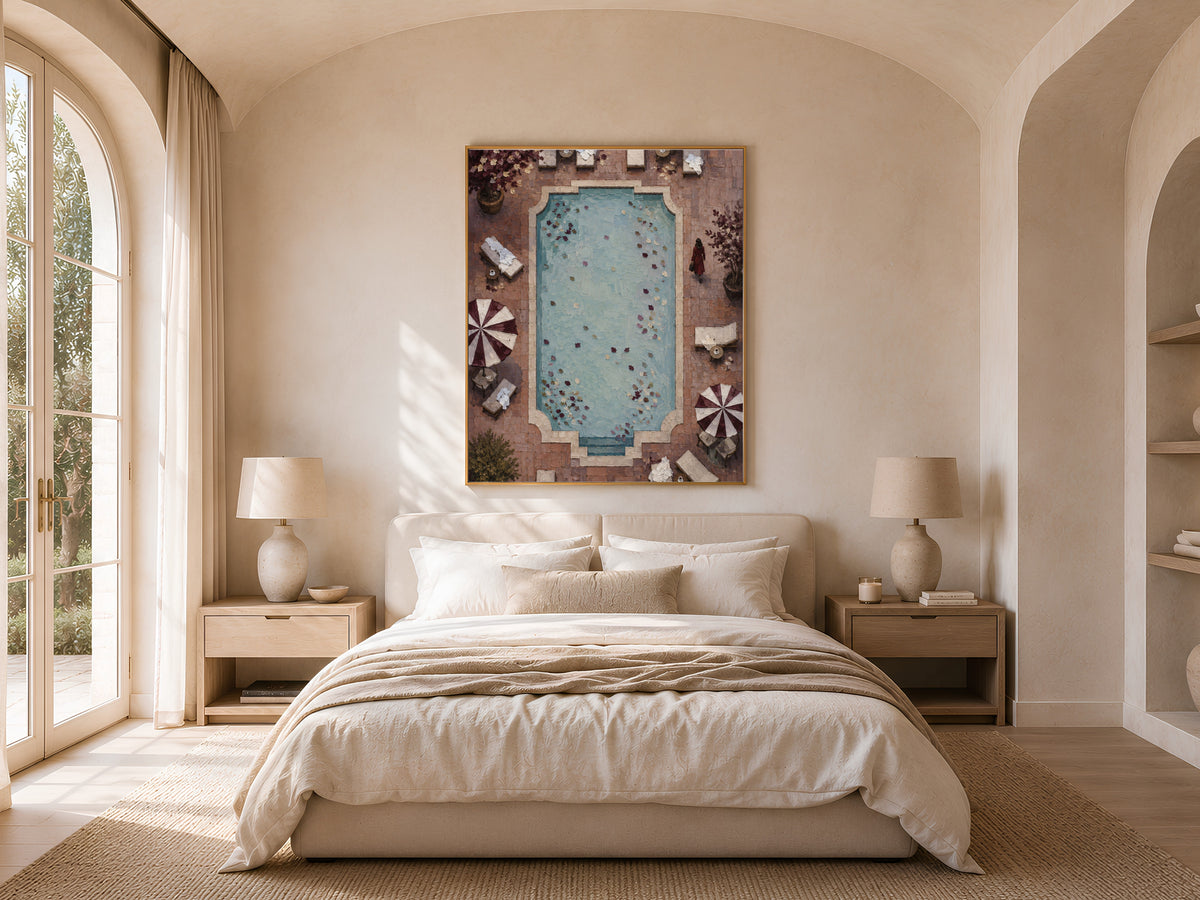 Aerial pool wall art framed above bed in warm neutral arched bedroom decor