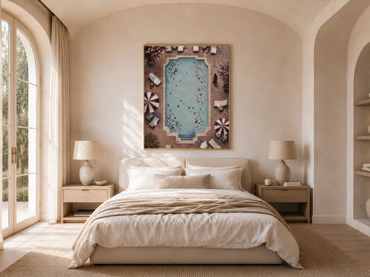 Aerial pool wall art framed above bed in warm neutral arched bedroom decor