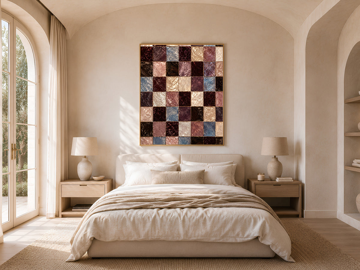 Checkerboard mosaic print framed above a bed in a neutral arched bedroom