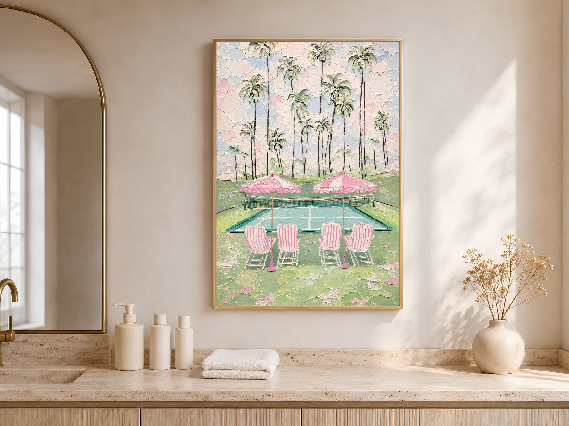Pink tennis court print in gold frame on sideboard with white vases in neutral living room
