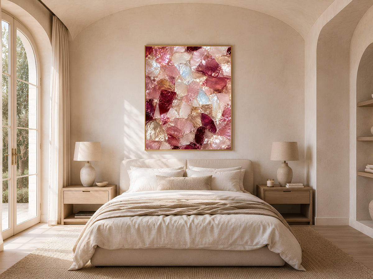 Pink crystal abstract print framed above a bed in a neutral arched bedroom