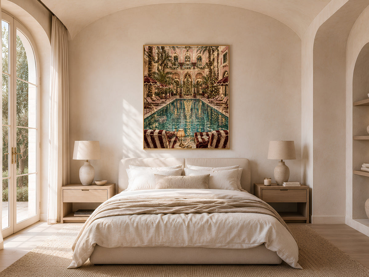 Indoor pool Christmas print framed above a bed in a neutral arched bedroom