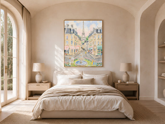 Impasto Paris street scene wall art in a gold frame above a bed with warm linen bedding and a rattan lamp in a bright minimal bedroom with arched windows
