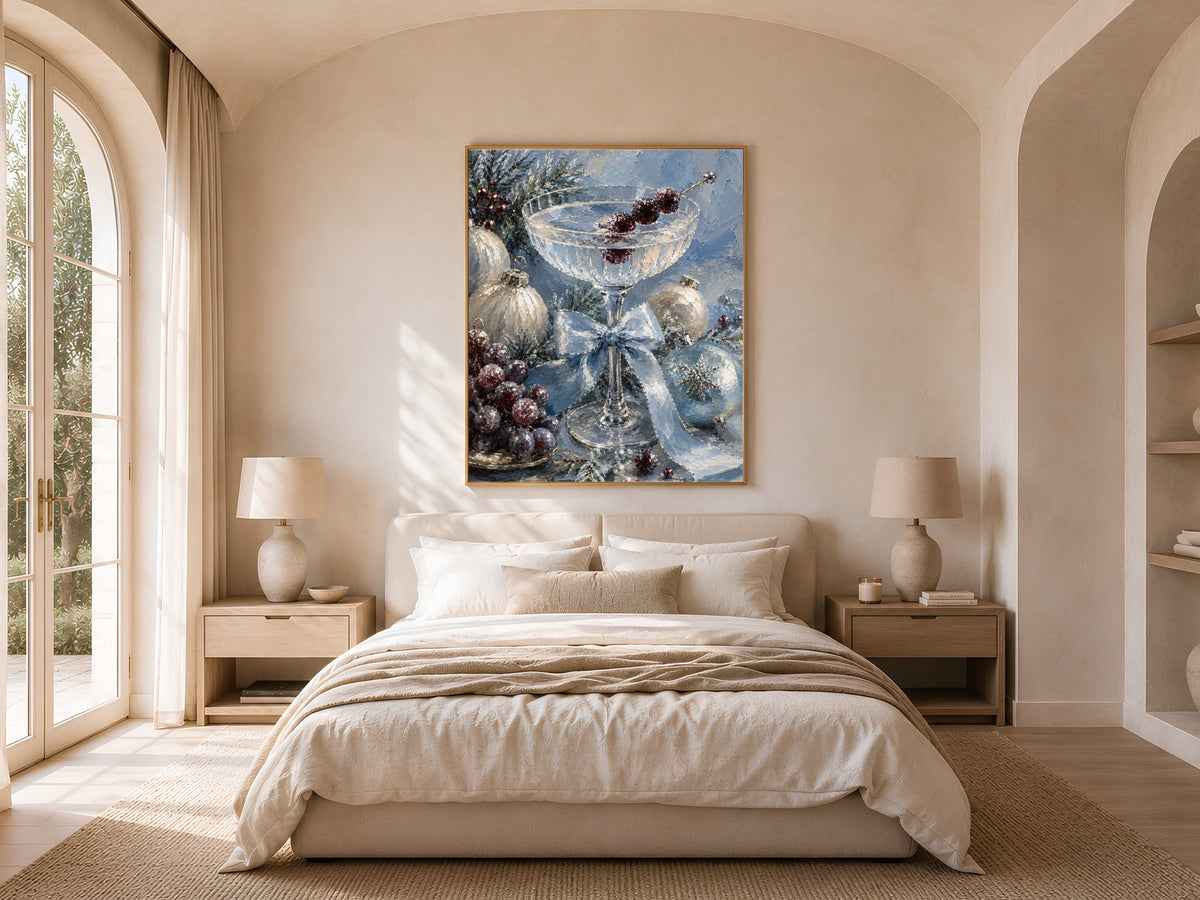 Champagne coupe still life framed above a bed in a neutral arched bedroom