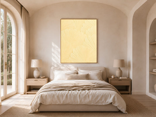 Butter yellow mosaic print framed above a bed in a warm neutral bedroom with arched windows