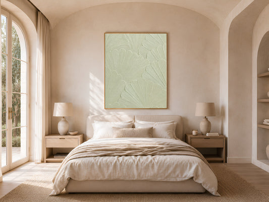 Celadon textured print framed above a bed in a warm neutral bedroom with nightstand lamps
