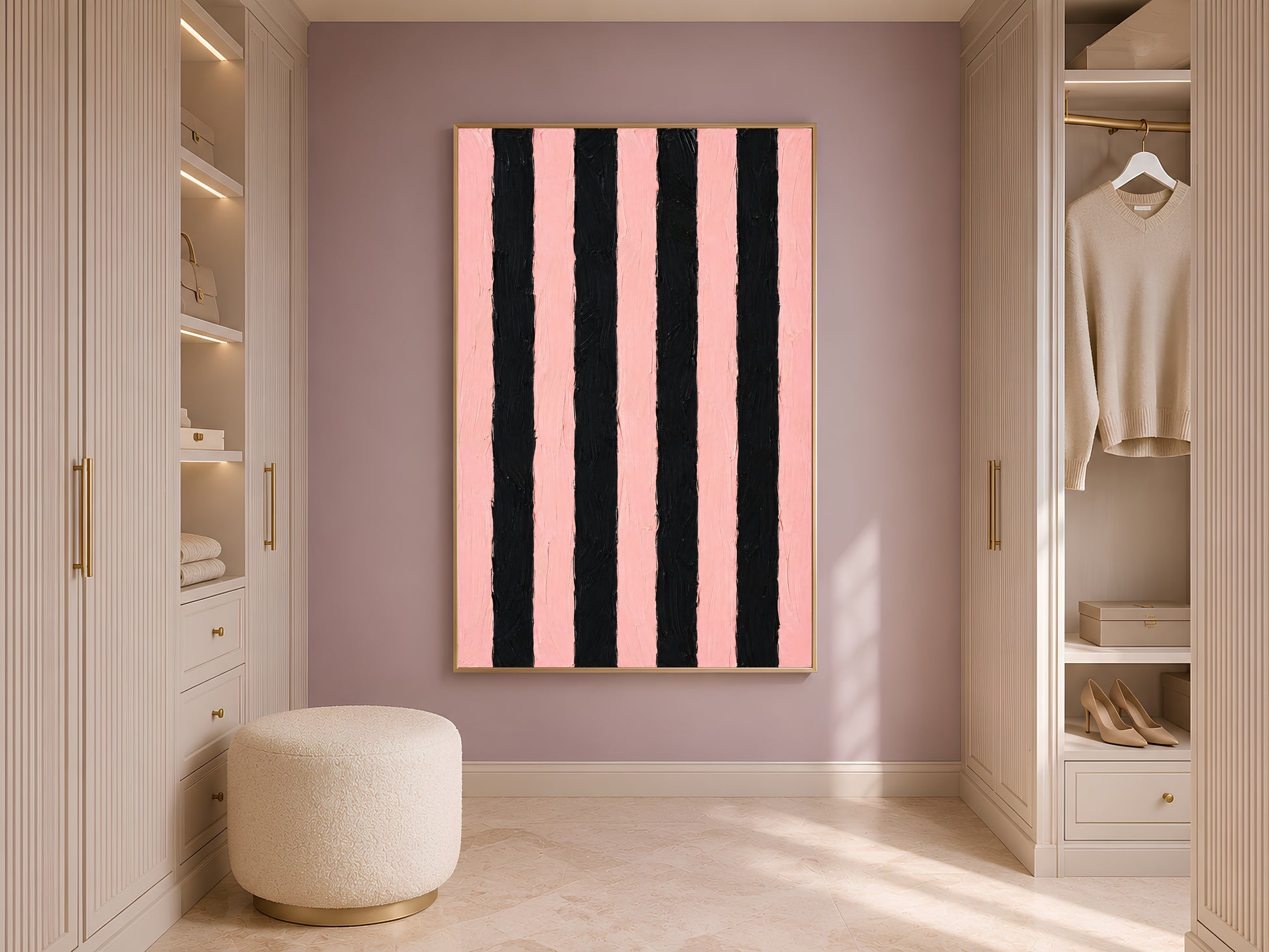 Bold pink and black stripe print in gold frame in styled dressing room with wardrobe and cream ottoman
