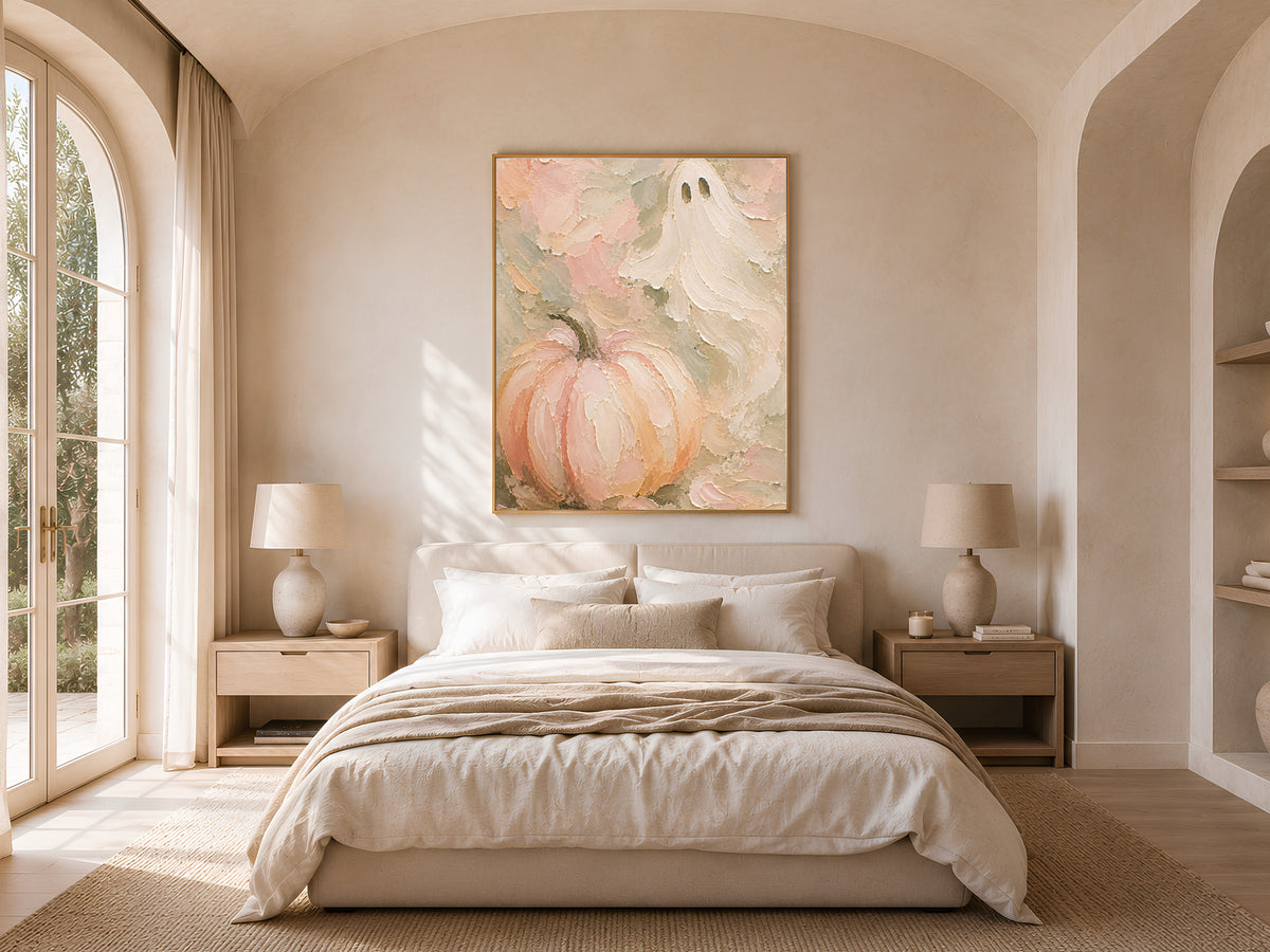 Pastel ghost and pumpkin wall art print framed above a bed in a light-filled arched bedroom