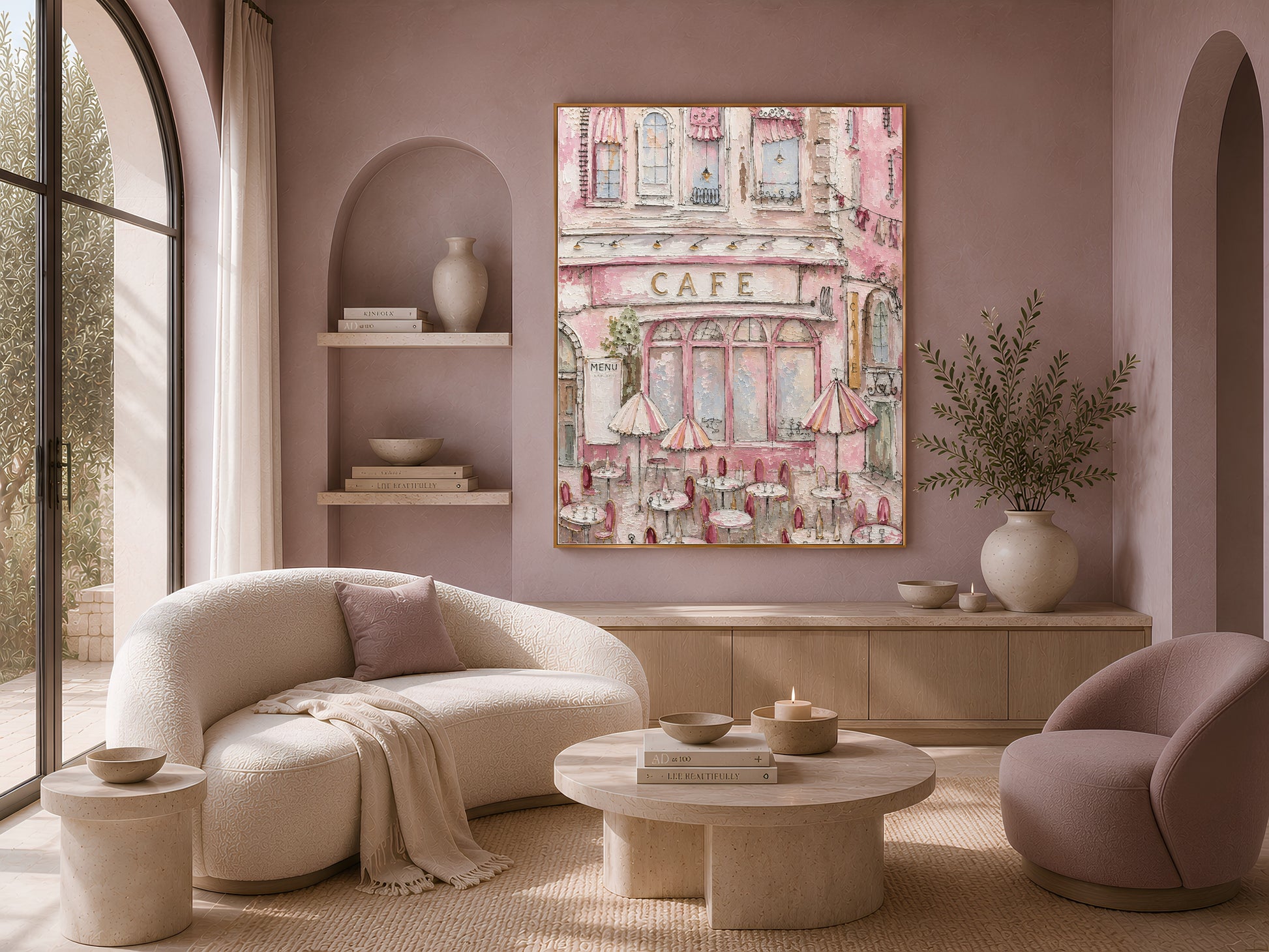 Textured Parisian cafe painting in a gold frame above a living room with a curved boucle sofa and armchair
