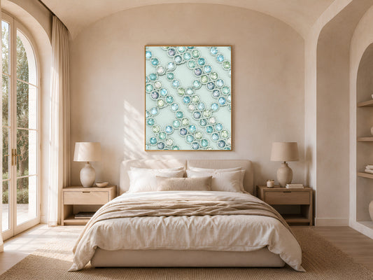 Crystal gemstone wall art framed above a bed in a warm neutral bedroom with arched windows