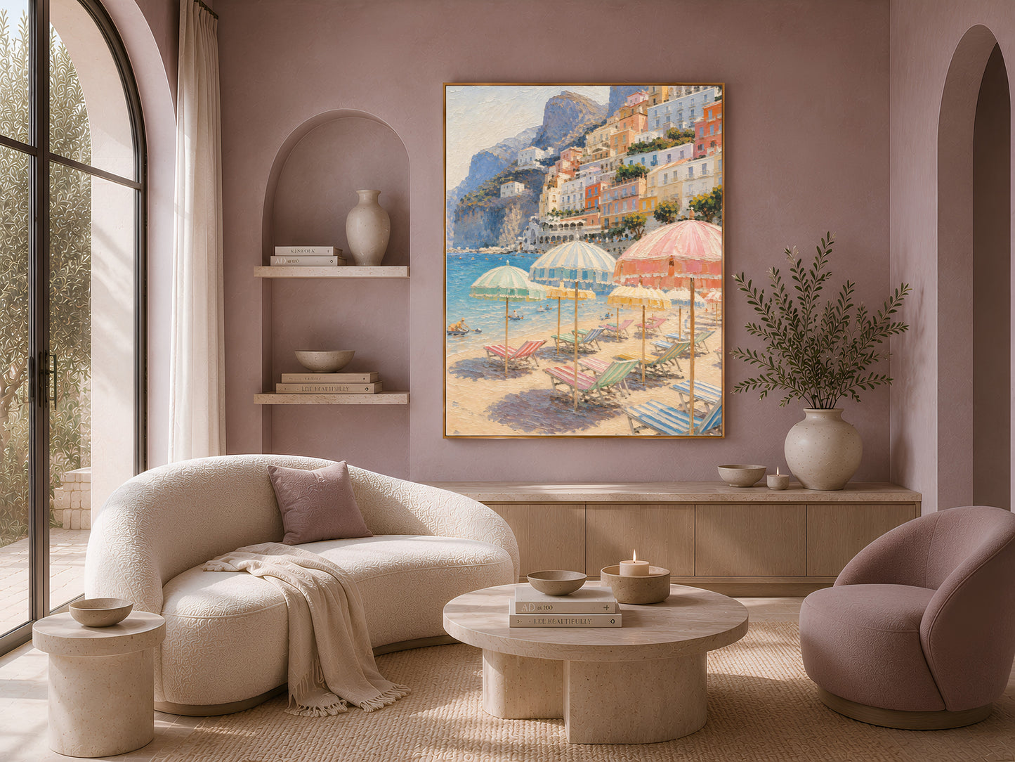 Framed Amalfi coast print above a cream sofa in a mauve arched-shelf living room
