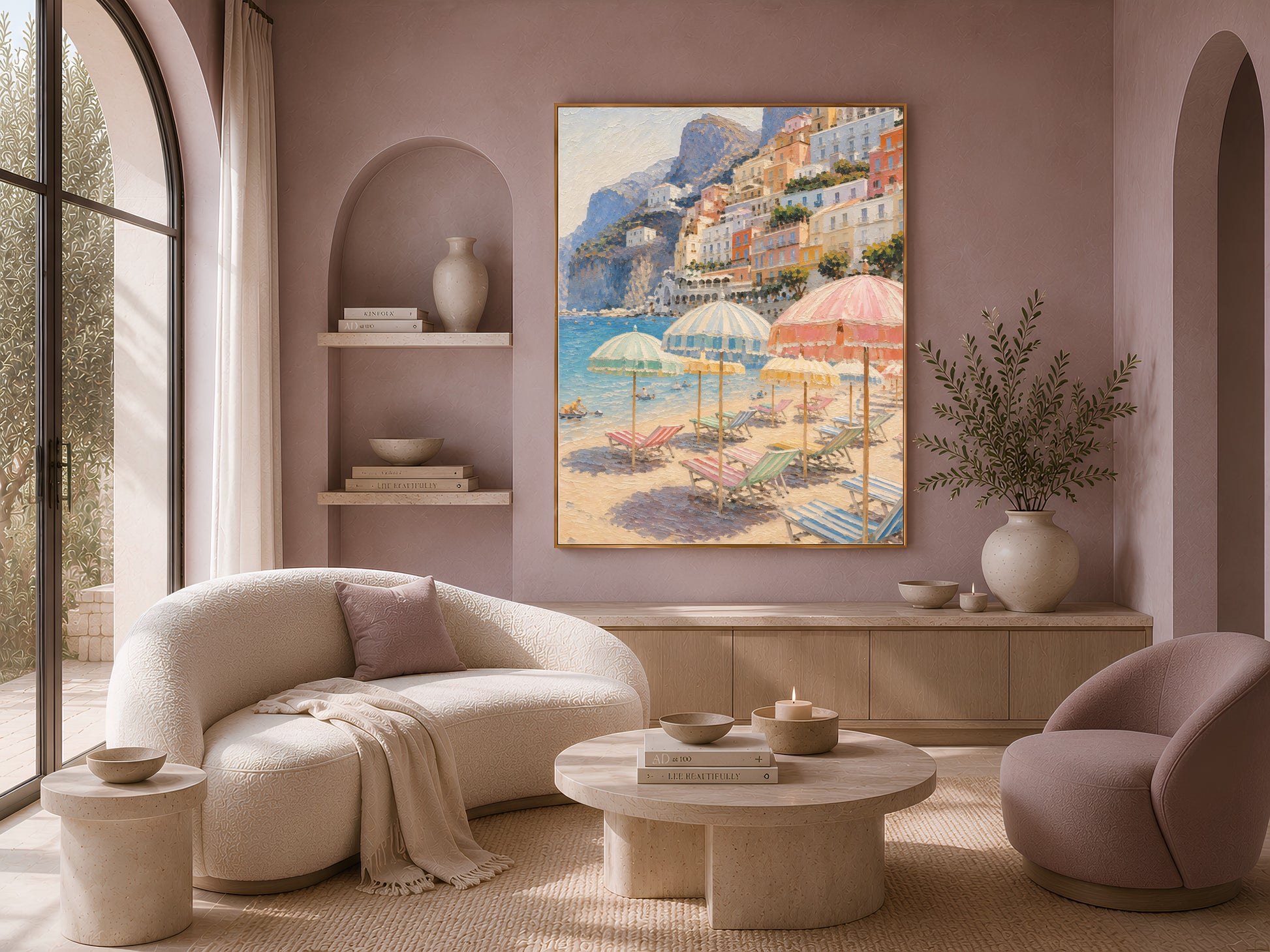 Framed Amalfi coast print above a cream sofa in a mauve arched-shelf living room
