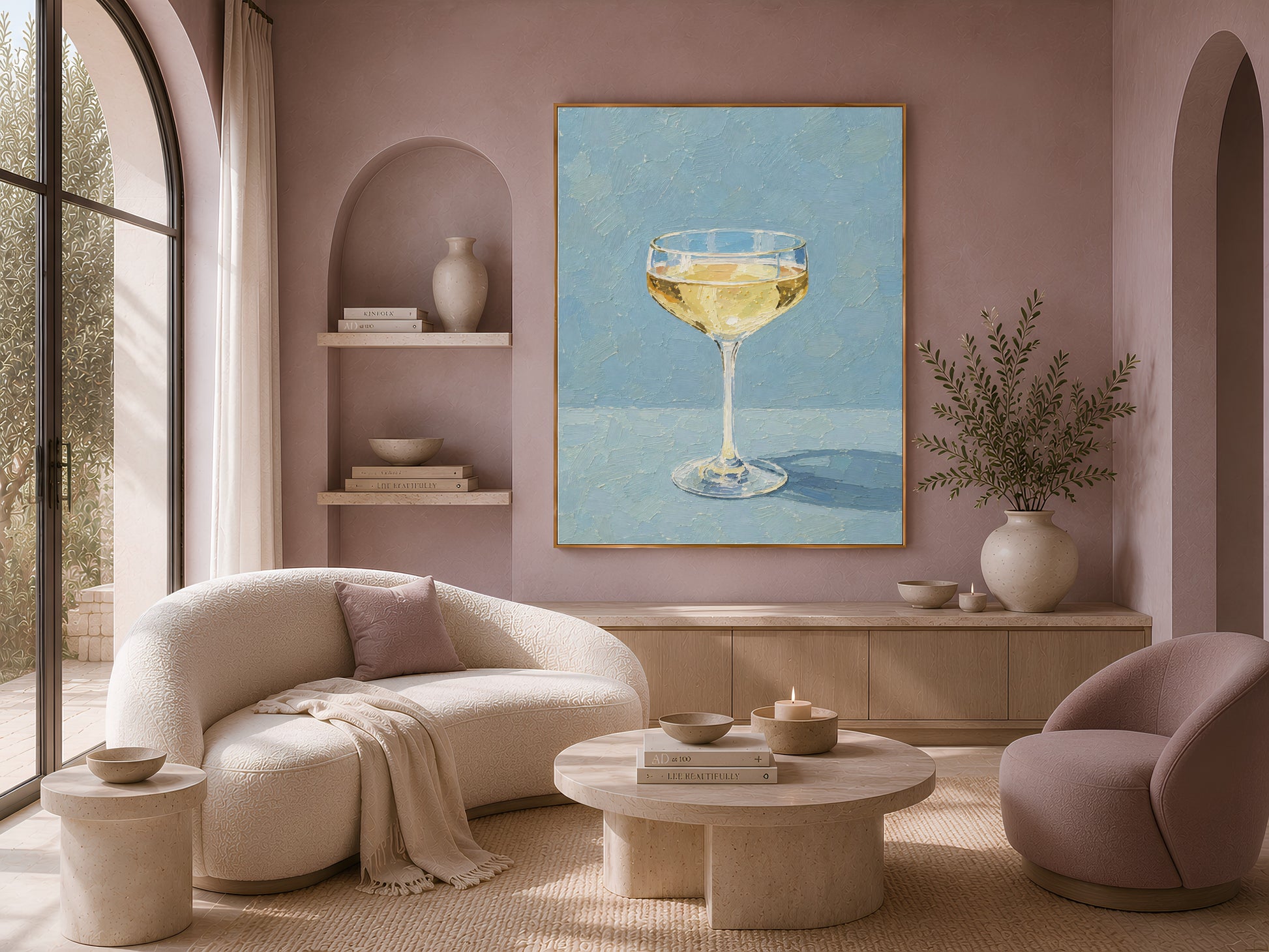 Champagne coupe print in gold frame above a cream sofa in a soft neutral living room