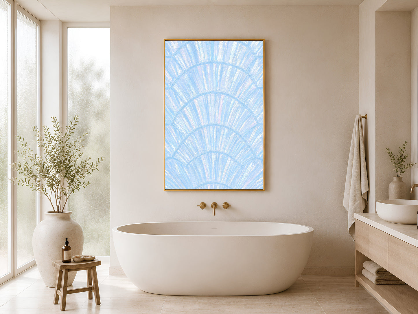 Blue iridescent capiz shell print in gold frame hung in a minimal white bathroom with freestanding bathtub and wood stool