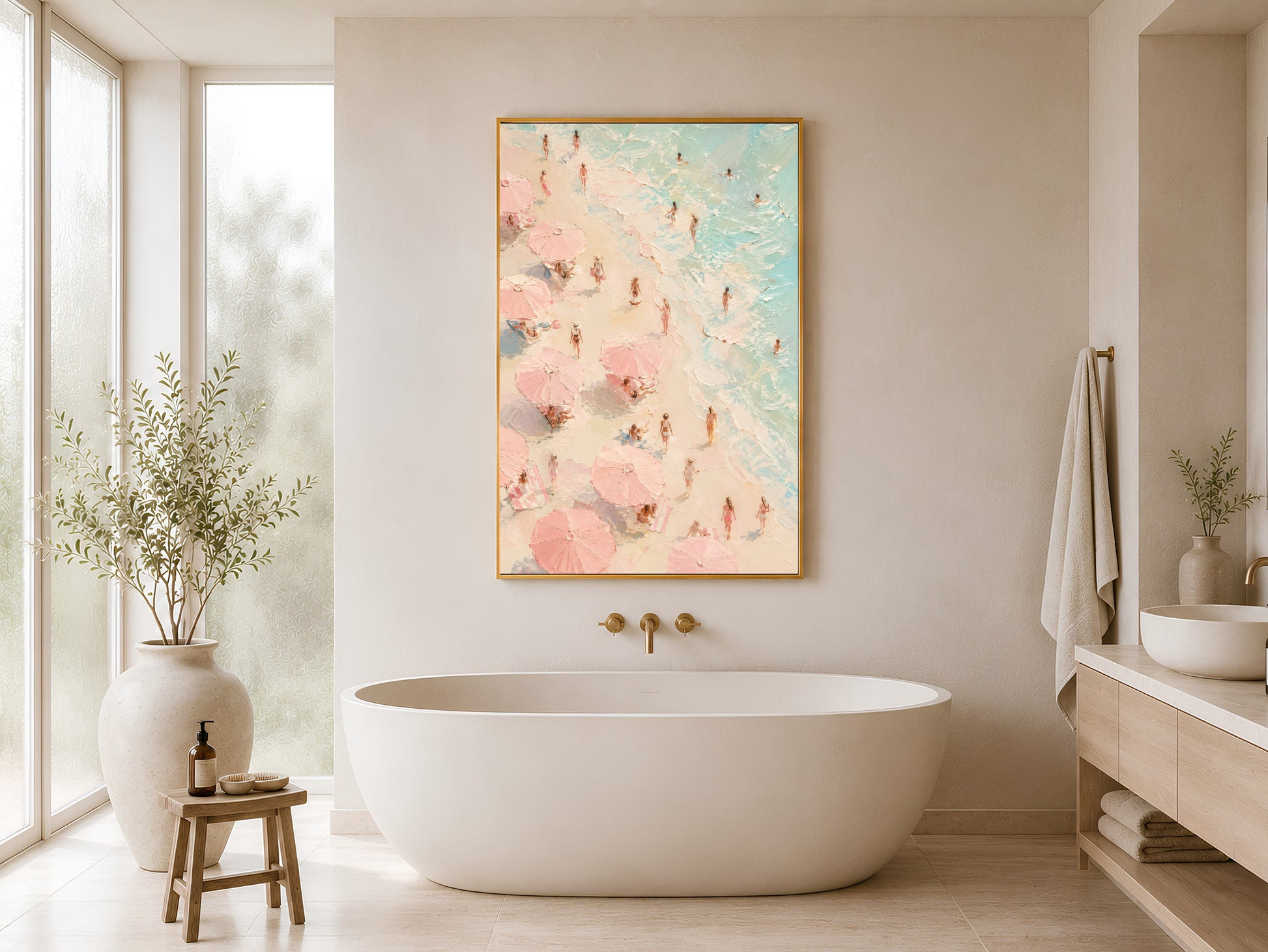 Pink coastal beach scene print in gold frame hung in a minimal white bathroom with freestanding bathtub and wood stool