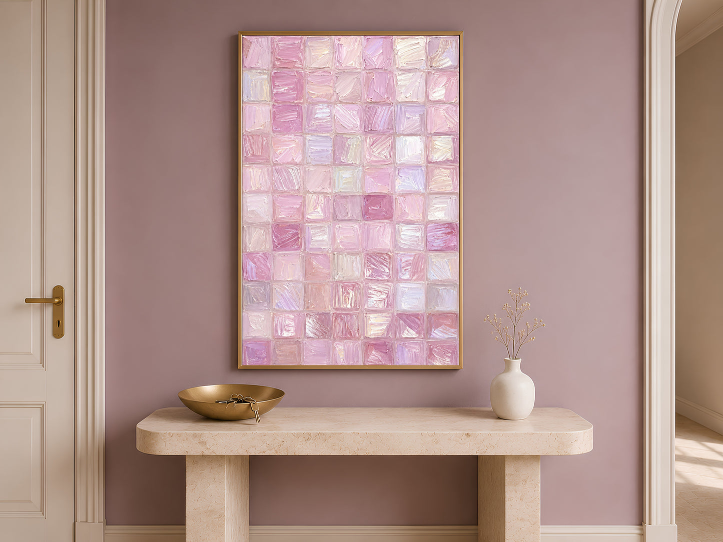 Pink impasto mosaic tile print in gold frame on travertine console table in hallway with mauve accent wall and bowl
