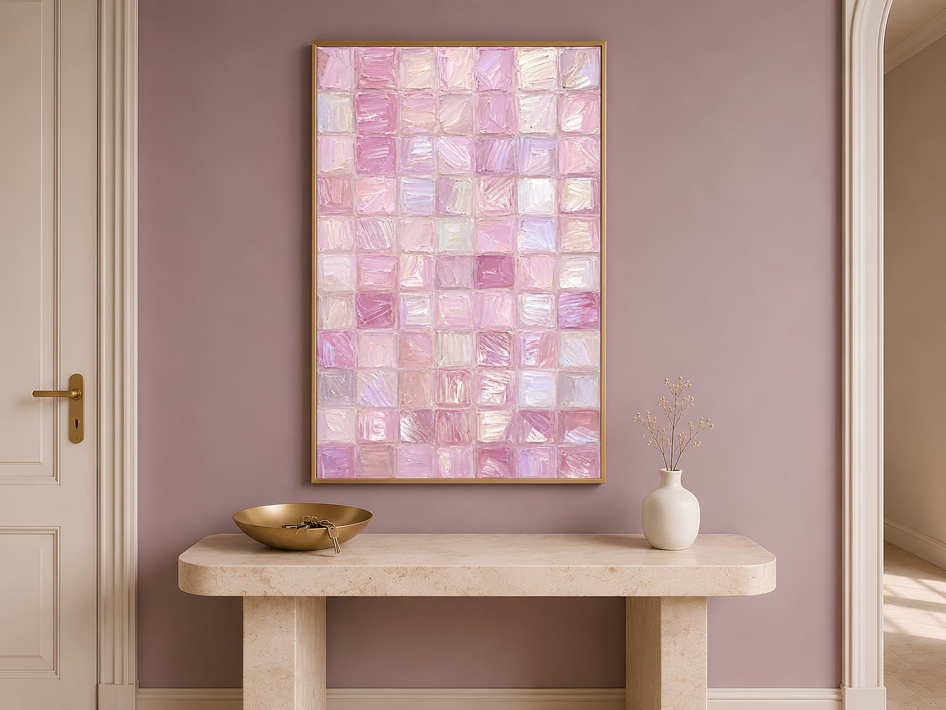 Pink impasto mosaic tile print in gold frame on travertine console table in hallway with mauve accent wall and bowl

