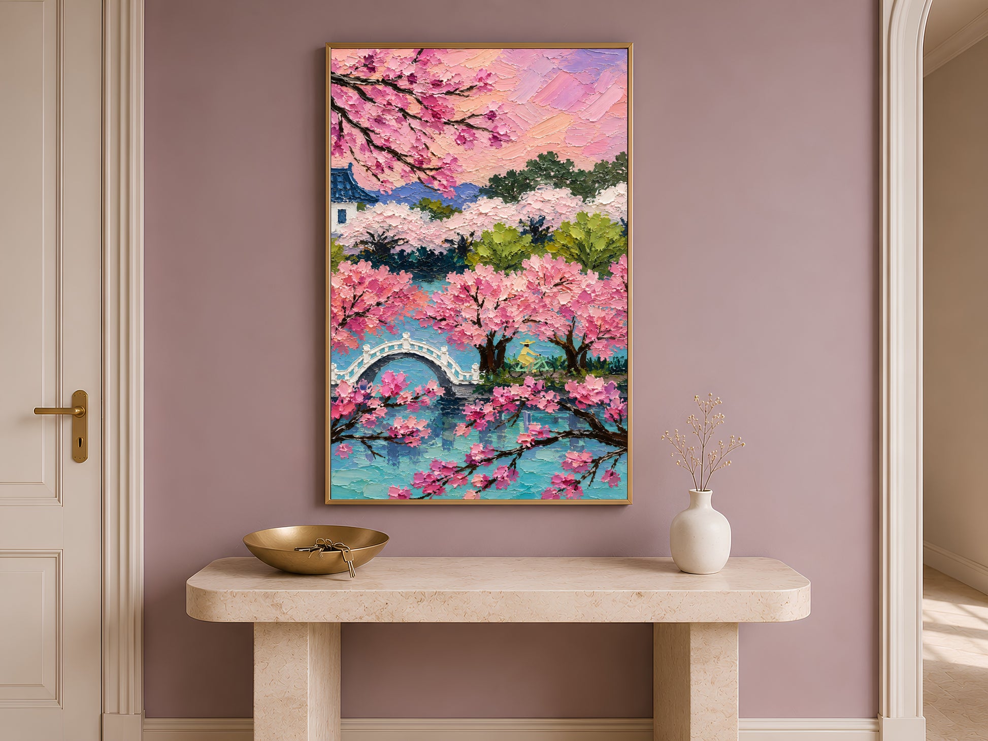 Cherry blossom sakura landscape wall art in gold frame on travertine console table in hallway with mauve accent wall
