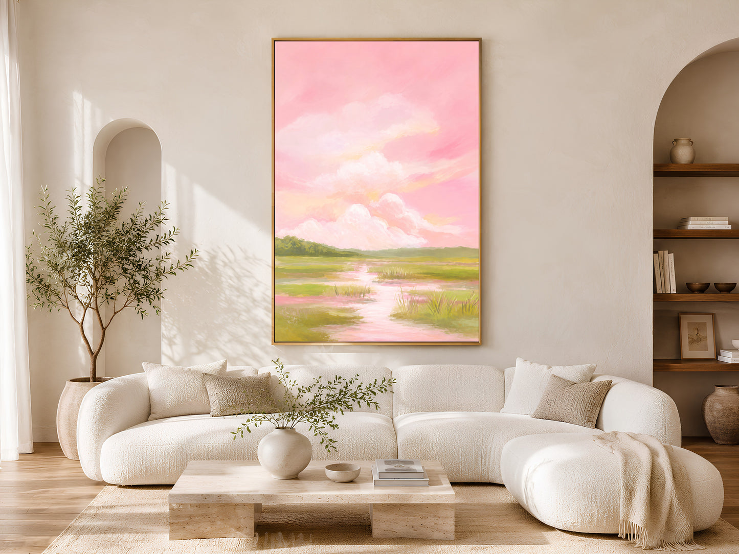 Pink sky marsh landscape wall art above white sofa in sunlit arched living room
