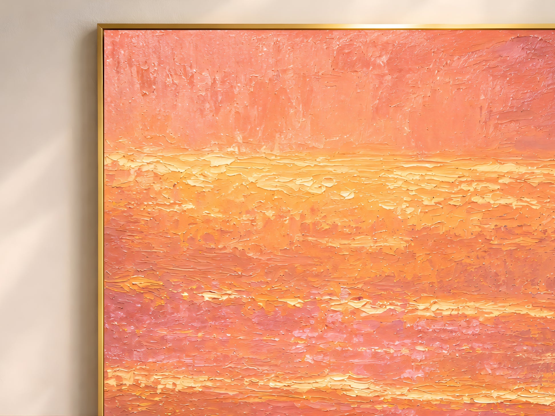 Close-up detail of pink sunset beach wall art showing thick impasto-style texture, glowing golden reflections, and layered peach skies.