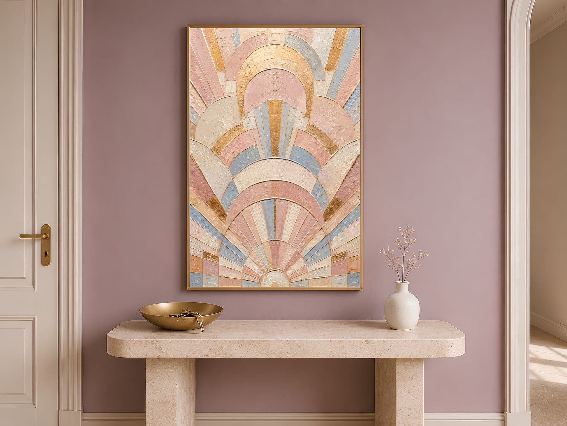 Pastel art deco wall art in gold frame leaning against travertine console table in hallway
