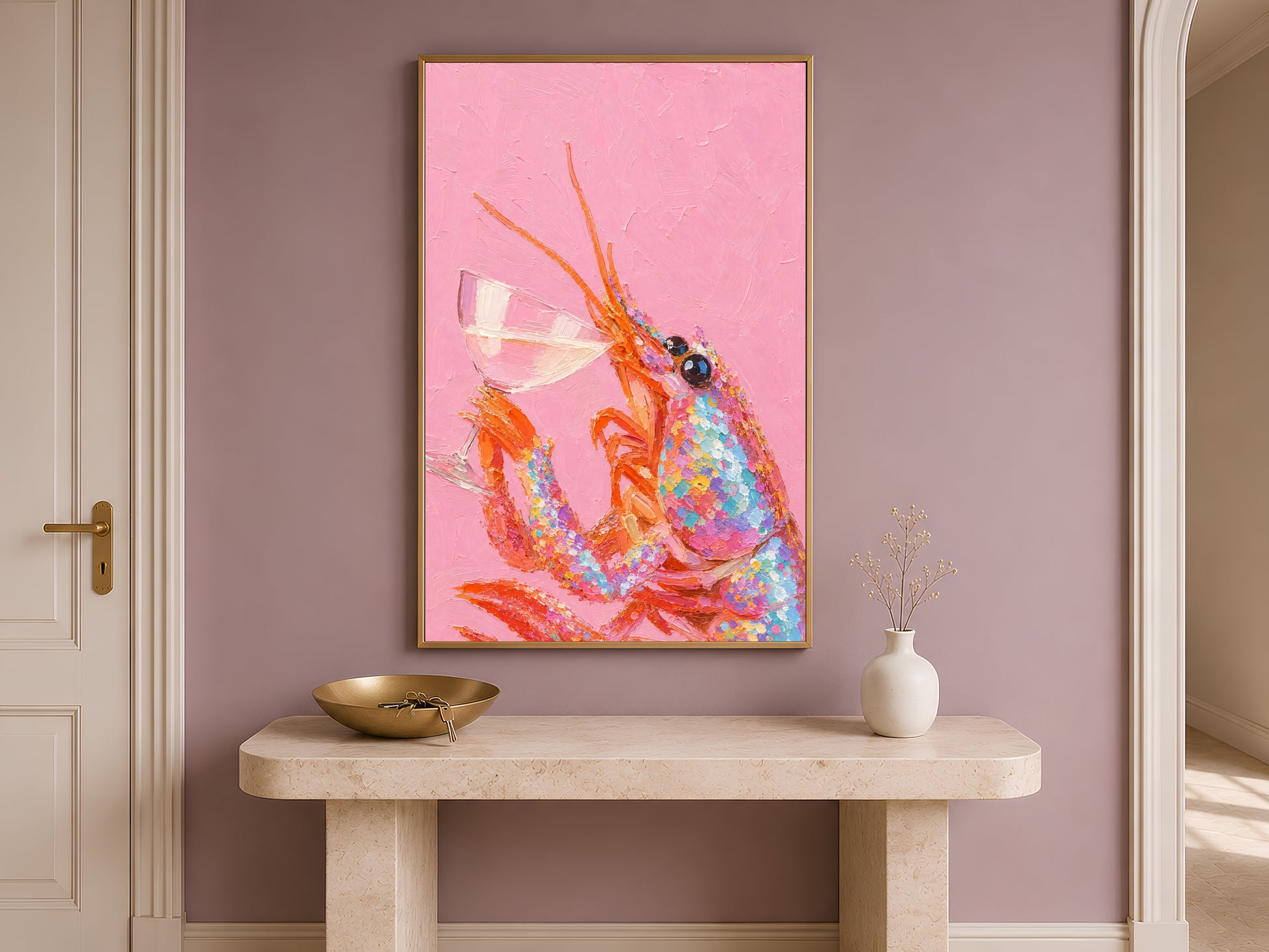 Pink lobster print in gold frame on travertine console table in hallway with mauve accent wall and bowl
