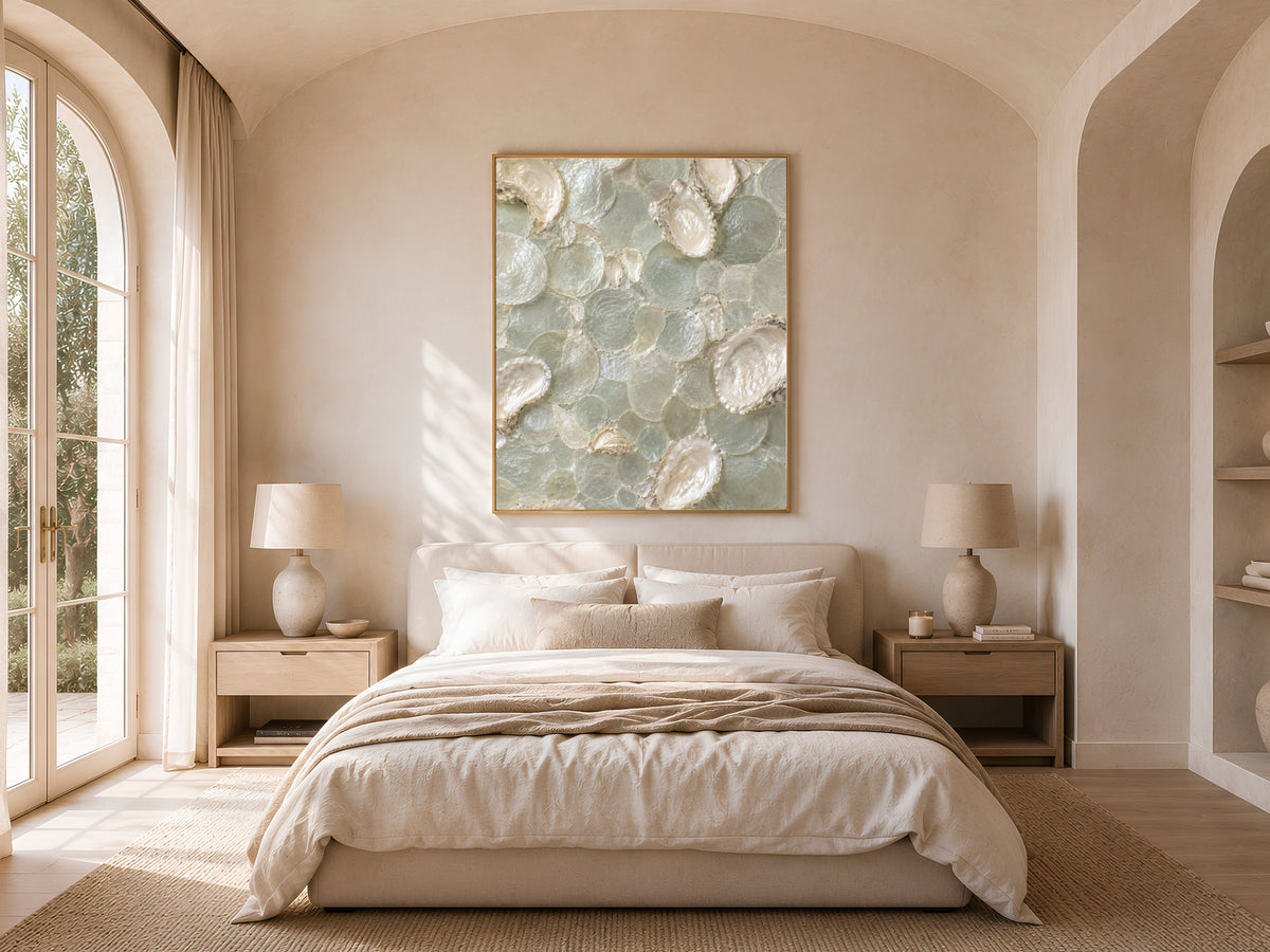 Coastal sage green mosaic print in a gold frame above a bed in a neutral, arched-window bedroom