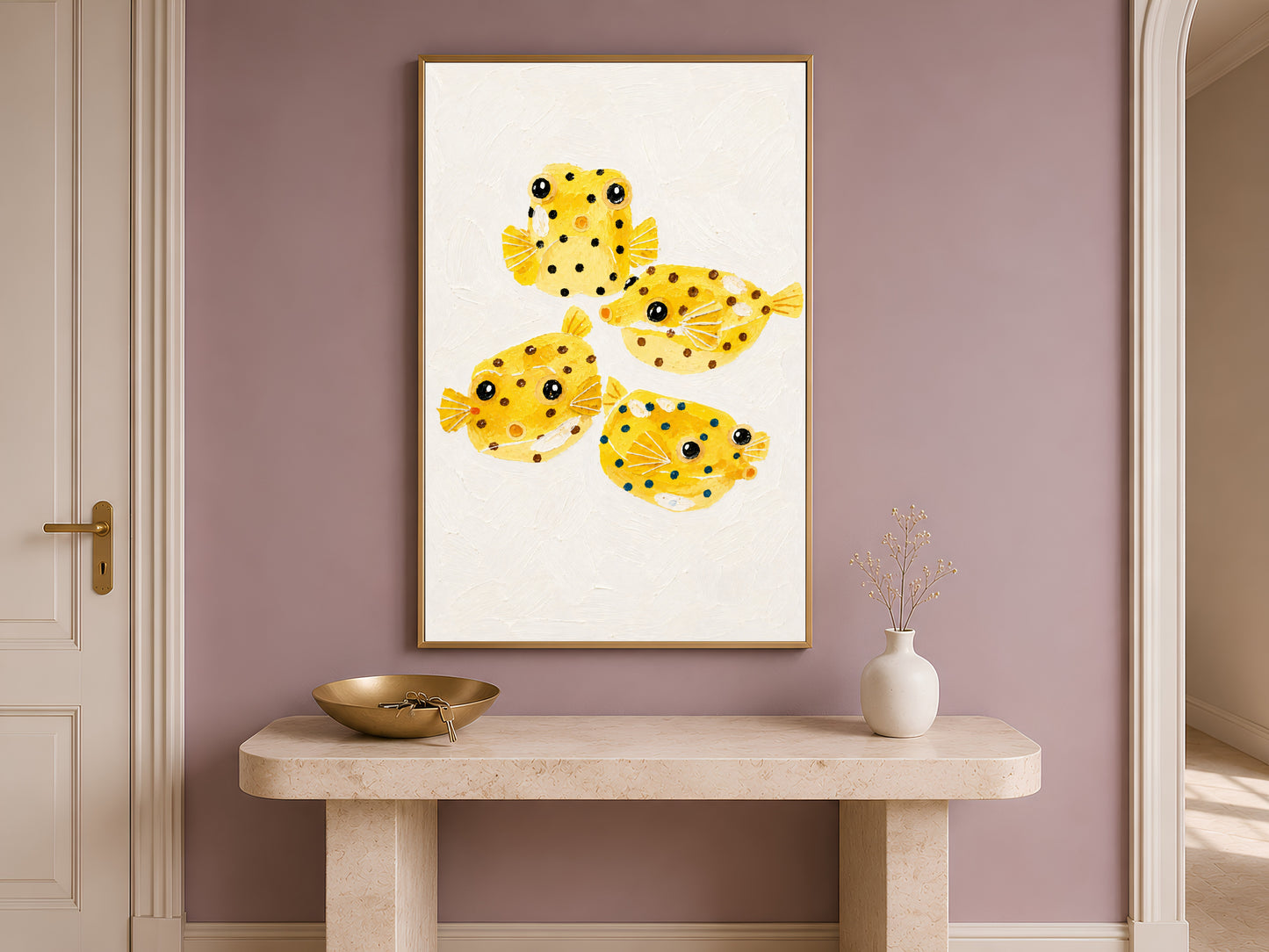 Yellow boxfish painting framed on an entryway wall above a wooden table
