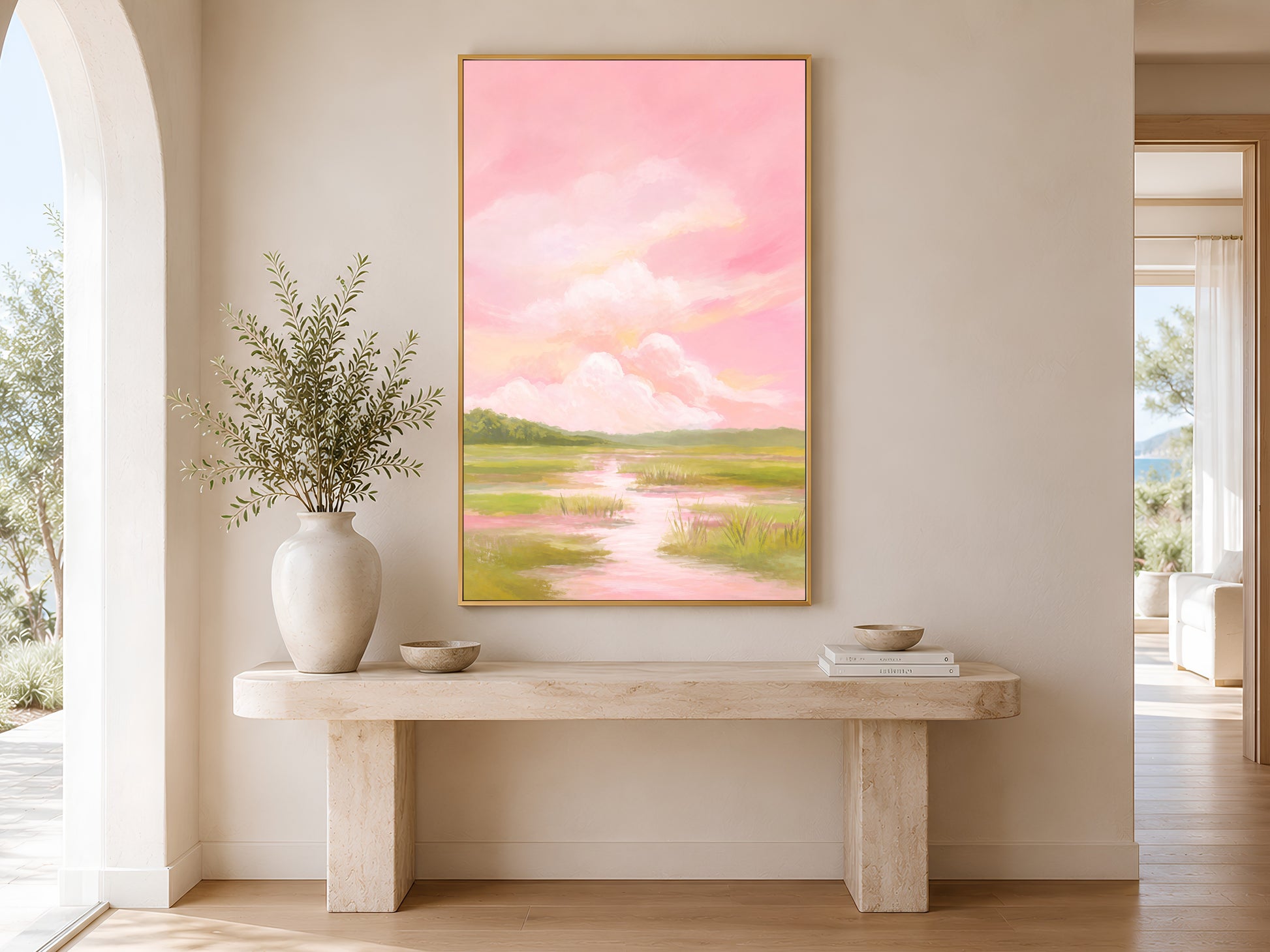 Pink sky marsh landscape wall art above console table in sunlit hallway
